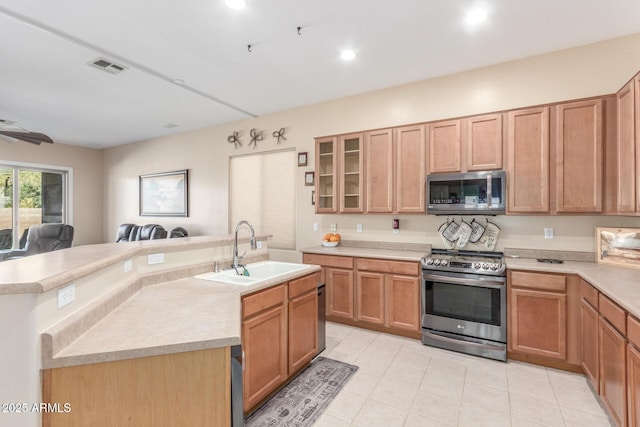 kitchen featuring appliances with stainless steel finishes, a center island with sink, and sink