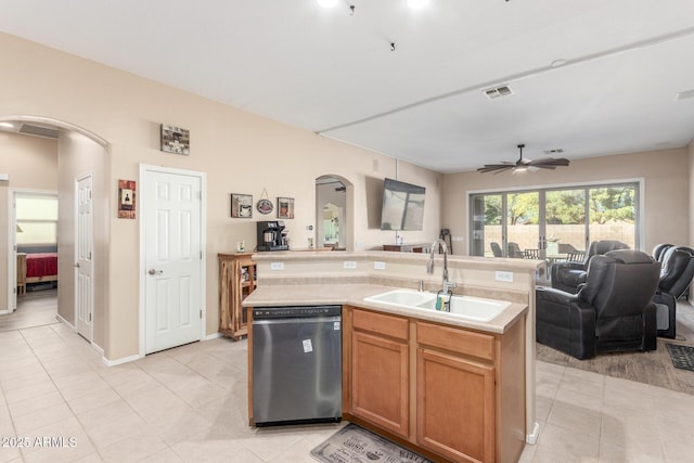 kitchen featuring ceiling fan, sink, an island with sink, and stainless steel dishwasher