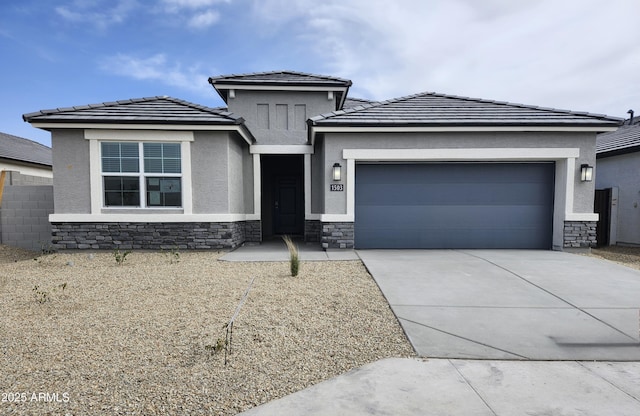 1584 S 241st Ave, Buckeye, AZ 85326 - prairie-style home featuring stone siding, a garage, driveway, stucco siding, and a tiled roof