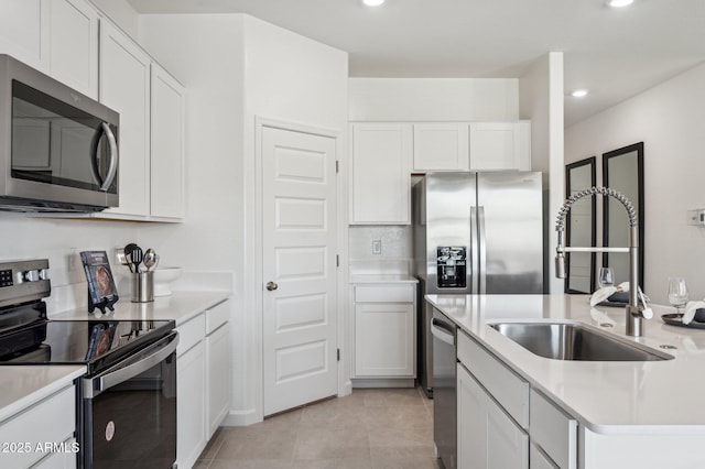 1584 S 241st Ave, Buckeye, AZ 85326 - kitchen with appliances with stainless steel finishes, light countertops, white cabinetry, recessed lighting, and a center island with sink
