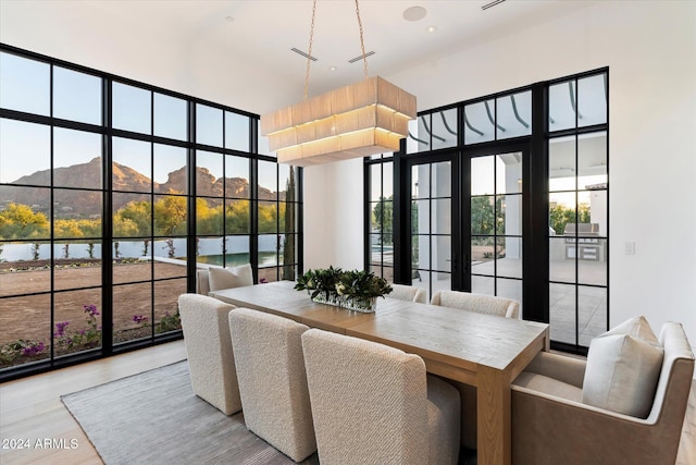 sunroom featuring a water view