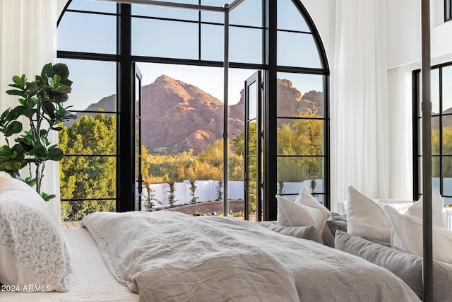 bedroom featuring a mountain view