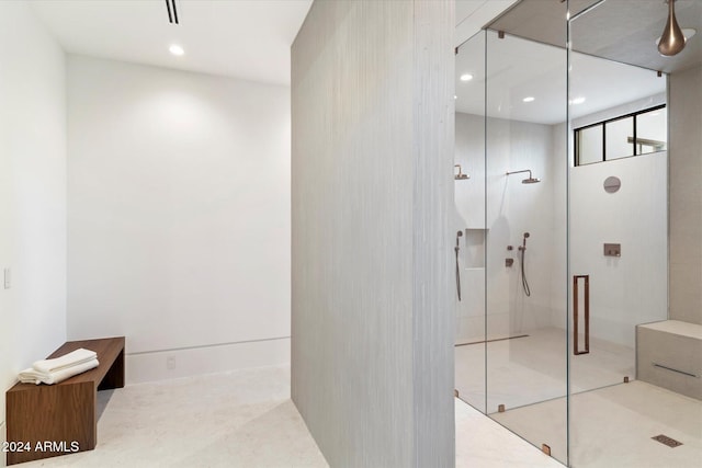 bathroom featuring a shower with shower door