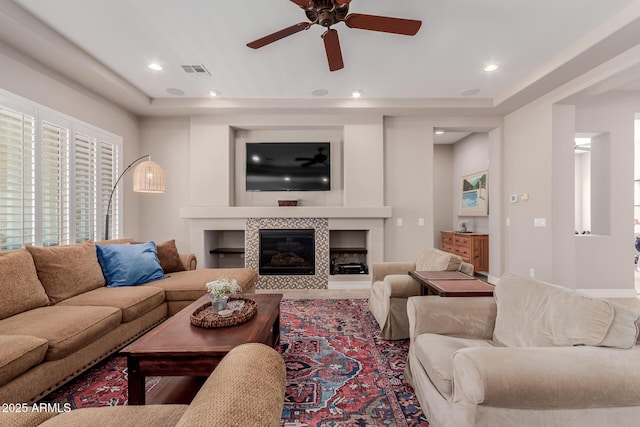 living room featuring recessed lighting, visible vents, a fireplace, and a ceiling fan