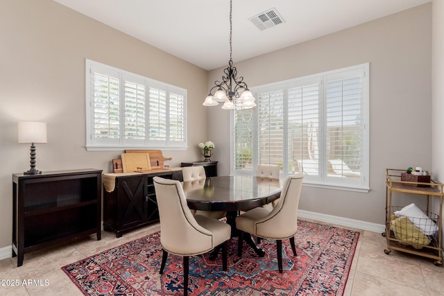 dining room featuring a wealth of natural light, visible vents, baseboards, and an inviting chandelier