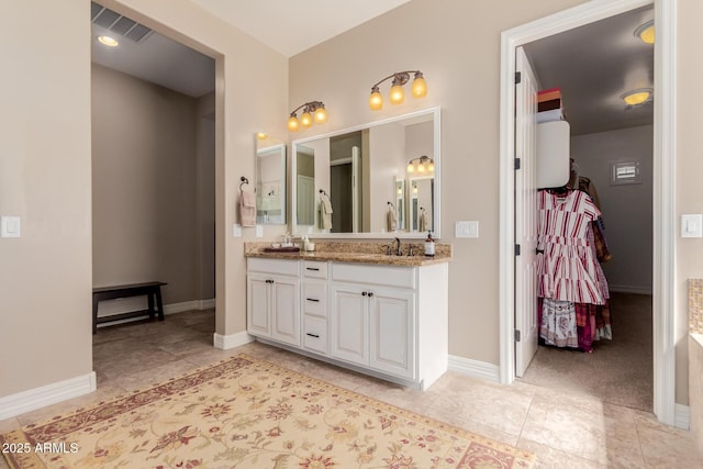 full bathroom with tile patterned flooring, visible vents, baseboards, and double vanity