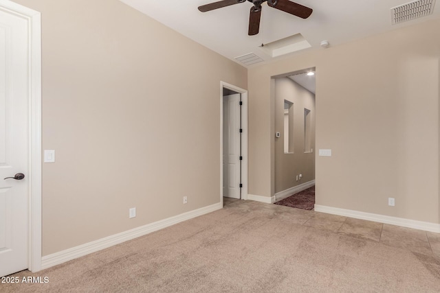 unfurnished room featuring carpet, a ceiling fan, visible vents, and baseboards