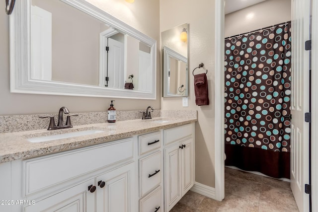 full bath featuring double vanity, curtained shower, tile patterned floors, and a sink