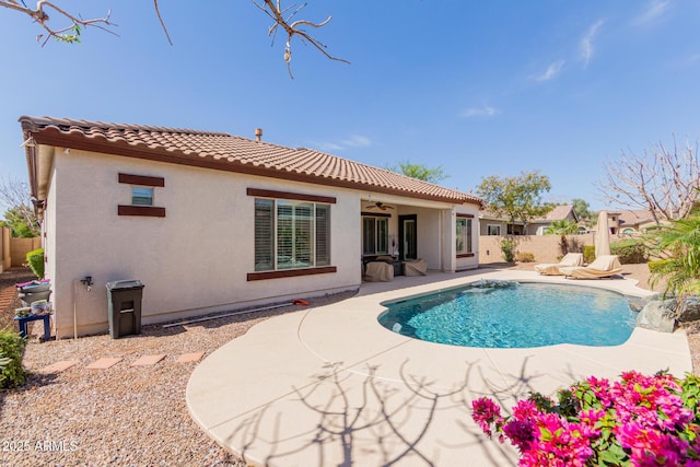 back of property featuring a tiled roof, a patio, a ceiling fan, and fence