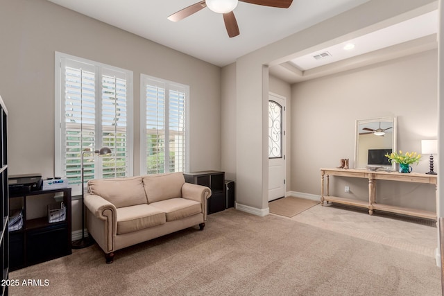 sitting room with visible vents, light colored carpet, baseboards, and ceiling fan