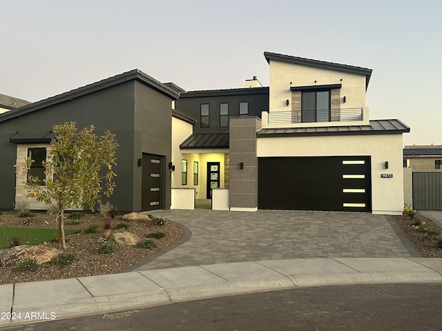 contemporary home with a balcony and a garage