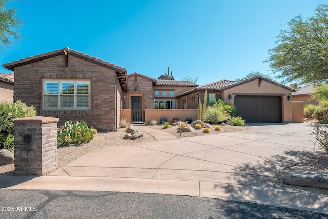 11070 E Bent Tree Dr, Scottsdale, AZ 85262 - view of front facade featuring concrete driveway, an attached garage, a tiled roof, stucco siding, and a gate