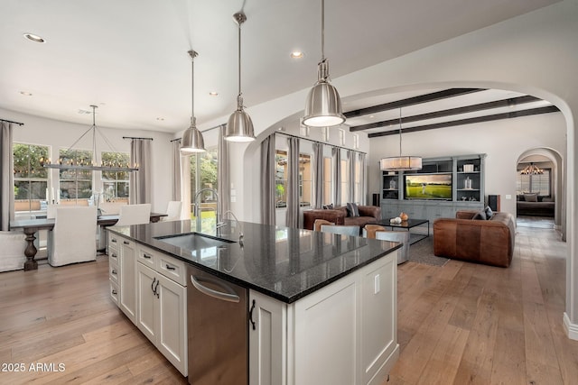 11070 E Bent Tree Dr, Scottsdale, AZ 85262 - kitchen with arched walkways, white cabinets, light wood finished floors, a chandelier, and recessed lighting