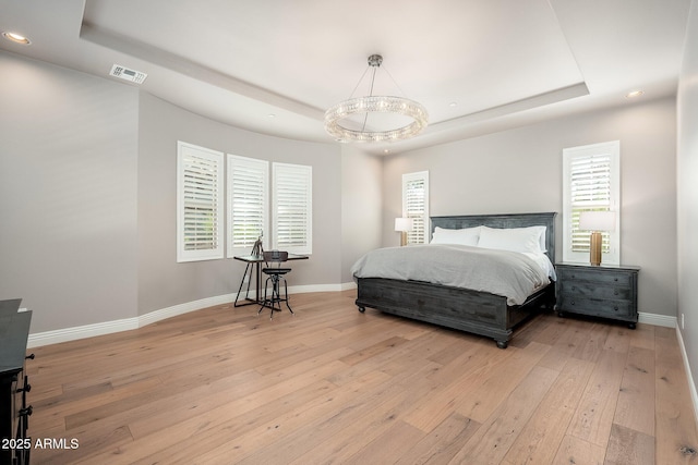 11070 E Bent Tree Dr, Scottsdale, AZ 85262 - bedroom featuring a tray ceiling, light wood-style flooring, and recessed lighting