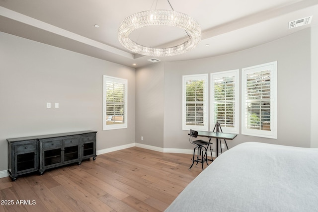 11070 E Bent Tree Dr, Scottsdale, AZ 85262 - bedroom featuring wood-type flooring, a raised ceiling, a chandelier, and recessed lighting