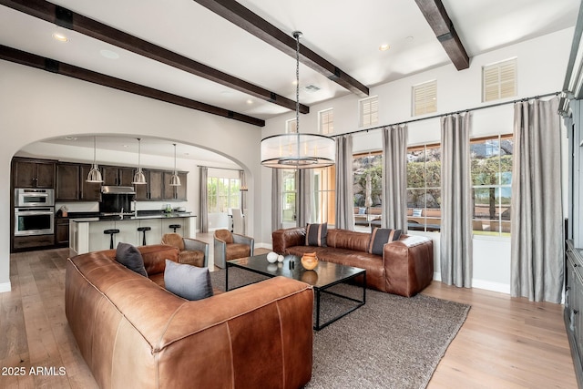 11070 E Bent Tree Dr, Scottsdale, AZ 85262 - living room with arched walkways, beam ceiling, light wood finished floors, and recessed lighting