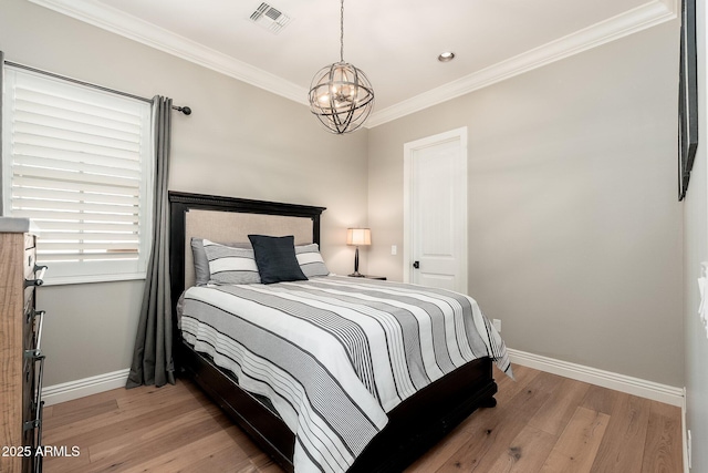 11070 E Bent Tree Dr, Scottsdale, AZ 85262 - bedroom featuring a chandelier, light wood-type flooring, and ornamental molding