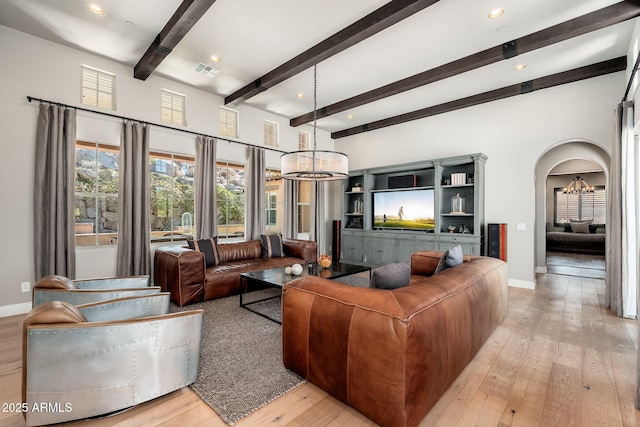 11070 E Bent Tree Dr, Scottsdale, AZ 85262 - living room with a chandelier, light wood-style floors, beamed ceiling, arched walkways, and recessed lighting