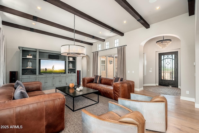 11070 E Bent Tree Dr, Scottsdale, AZ 85262 - living room featuring arched walkways, healthy amount of natural light, a chandelier, light wood-type flooring, and beamed ceiling