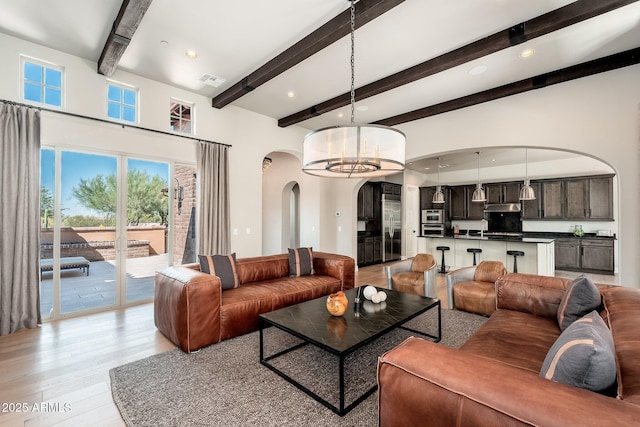 11070 E Bent Tree Dr, Scottsdale, AZ 85262 - living room with arched walkways, light wood-type flooring, beamed ceiling, recessed lighting, and a chandelier