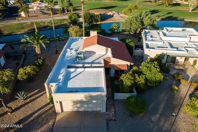 birds eye view of property with view of golf course and a water view