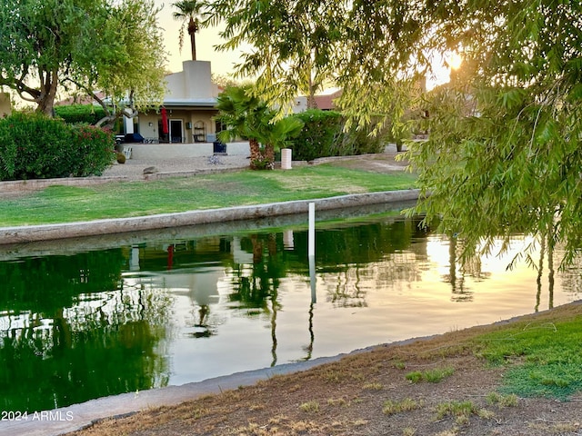 view of community featuring a lawn and a water view