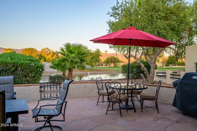 view of patio / terrace featuring a water view and grilling area