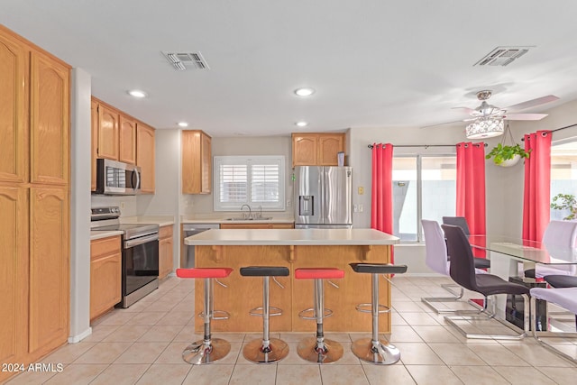 kitchen featuring light tile patterned floors, visible vents, stainless steel appliances, light countertops, and a sink