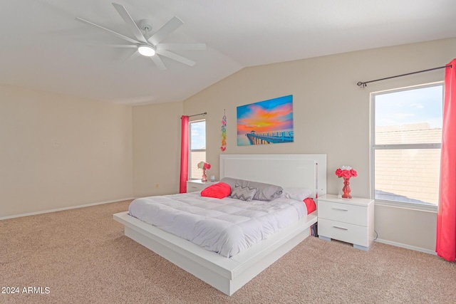 carpeted bedroom featuring a ceiling fan, vaulted ceiling, and baseboards