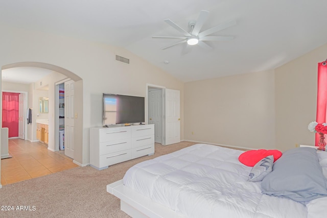 bedroom featuring arched walkways, light colored carpet, a ceiling fan, visible vents, and vaulted ceiling