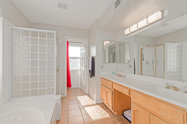 full bath with double vanity, visible vents, tile patterned flooring, a shower stall, and a sink