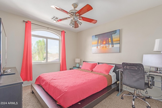 carpeted bedroom featuring baseboards, visible vents, and a ceiling fan