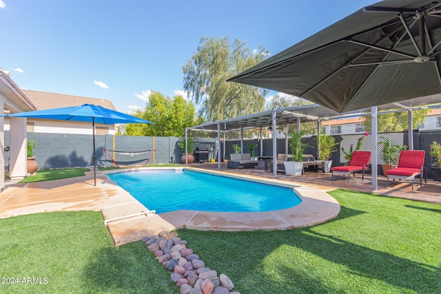 view of pool with a fenced in pool, a fenced backyard, a yard, and a wooden deck