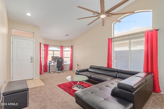 carpeted living room with lofted ceiling, visible vents, and a ceiling fan