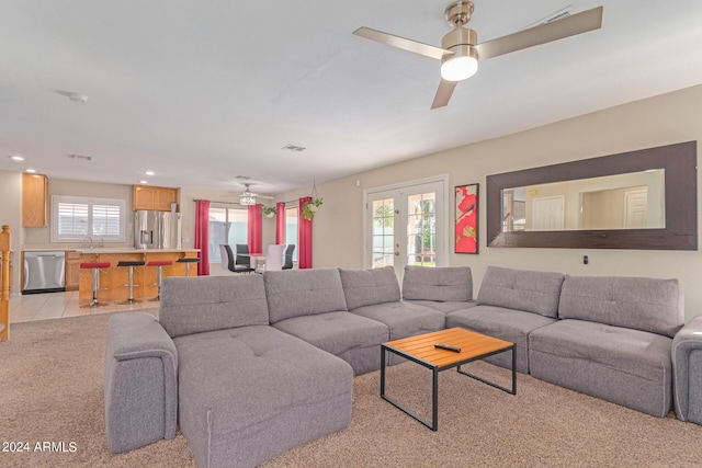 living area with light carpet, ceiling fan, light tile patterned flooring, french doors, and recessed lighting