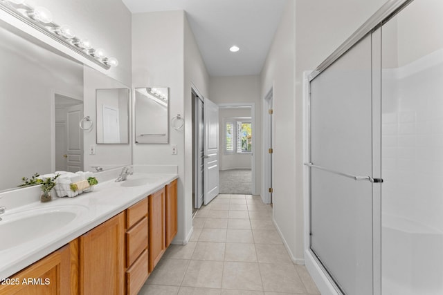 bathroom featuring a sink, a shower stall, and tile patterned floors