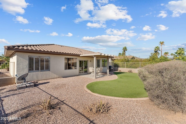 back of property with stucco siding, a patio, a tile roof, and a fenced backyard