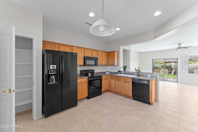 kitchen with a sink, black appliances, a peninsula, and recessed lighting