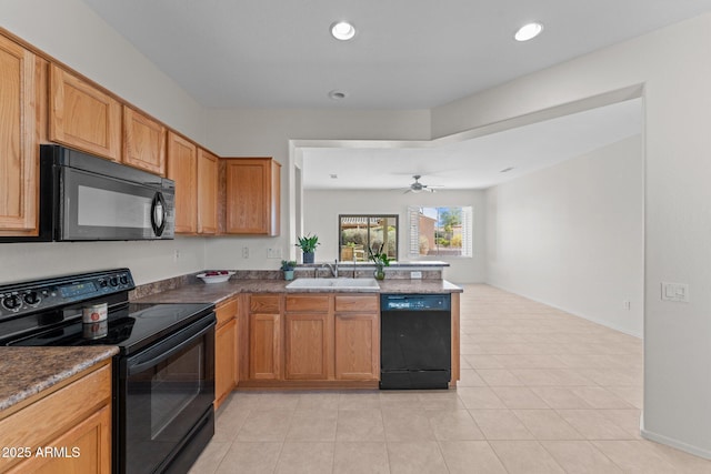 kitchen featuring open floor plan, recessed lighting, a peninsula, black appliances, and a sink