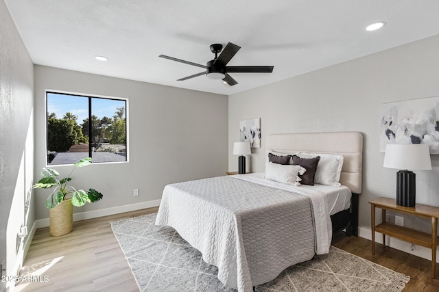 bedroom featuring baseboards, wood finished floors, a ceiling fan, and recessed lighting