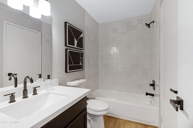 full bathroom with toilet, wood finished floors, bathtub / shower combination, and vanity