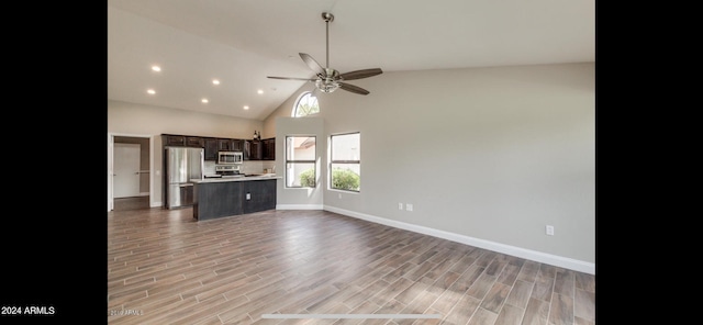 interior space featuring high vaulted ceiling, hardwood / wood-style floors, and ceiling fan