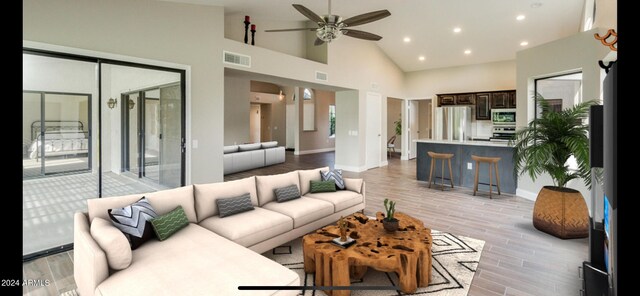 living room featuring ceiling fan, light hardwood / wood-style floors, and high vaulted ceiling