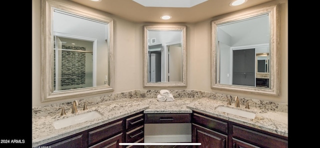 bathroom with an enclosed shower and vanity