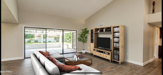 living room featuring high vaulted ceiling and dark wood-type flooring