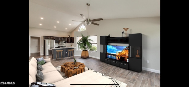 living room featuring high vaulted ceiling, ceiling fan, and light hardwood / wood-style flooring