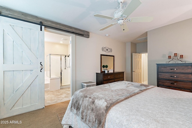 carpeted bedroom with a barn door, ceiling fan, and ensuite bathroom