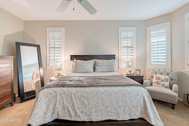 bedroom featuring light carpet and ceiling fan