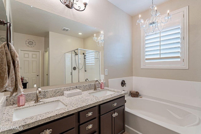 bathroom featuring shower with separate bathtub, vanity, and a chandelier