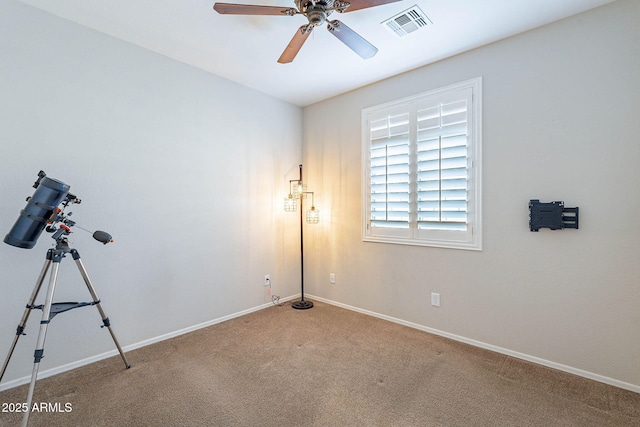 unfurnished room with ceiling fan and carpet flooring